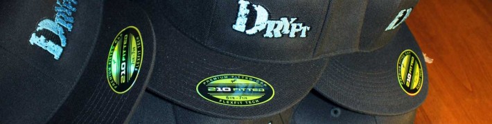 pile of DRYFT flat brim fishing hats